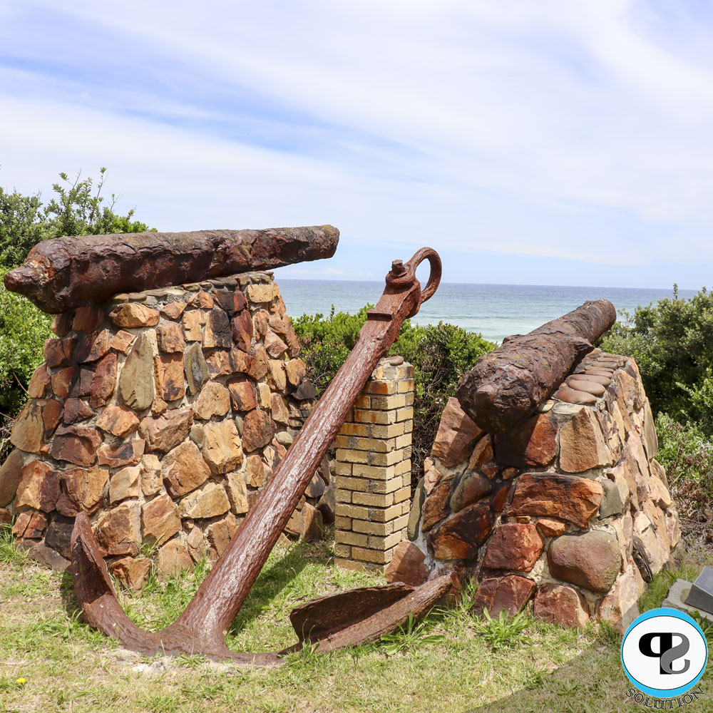 Rusted Cannons in front of Ocean with logo in corner